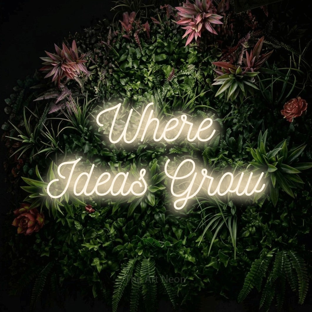 Enseigne néon à DEL à lumière blanche chaude, de style manuscrit, affichant « Where Ideas Grow » sur un mur de jardin fleuri, pour décorer un bureau