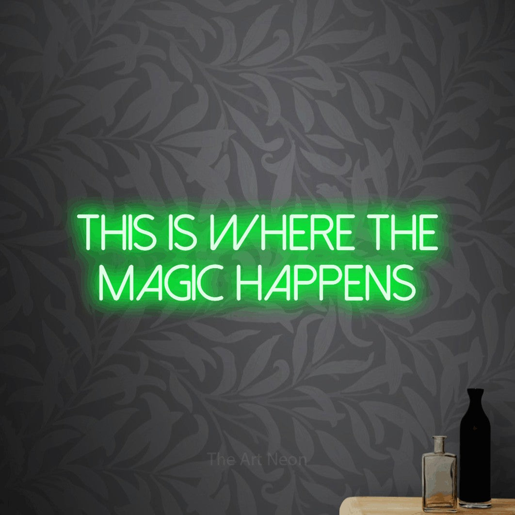 Green LED neon sign reading "This is Where the Magic Happens" against light grey floral wallpaper for office décor