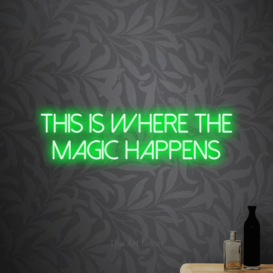 Green LED neon sign reading "This is Where the Magic Happens" against light grey floral wallpaper for office décor