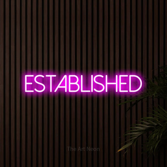 Pink LED neon sign reading "Established" against dark wooden slats for office décor