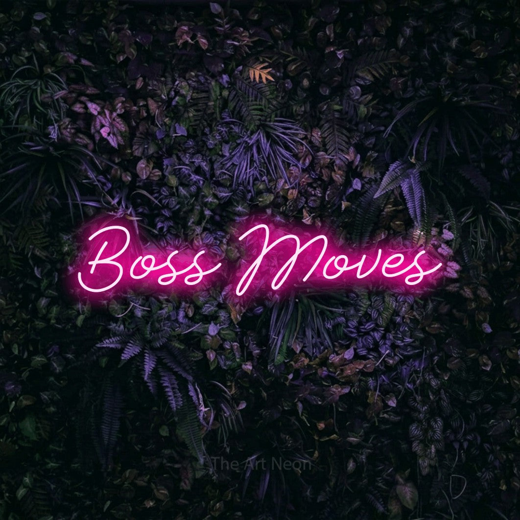 Hot pink script-style LED neon sign reading "Boss Moves" against a purple floral wall for office décor