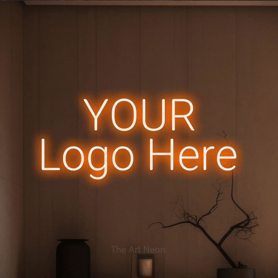 Orange LED neon sign reading "Your Logo Here" against a warm brown wall for office décor