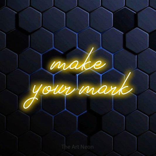 Yellow script-style LED neon sign reading "Make Your Mark" against a blue hexagonal wall for office décor