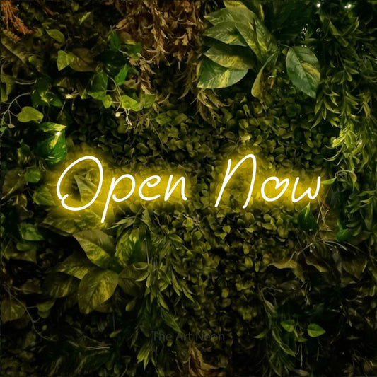Yellow LED neon sign reading "Open Now" against a textured moss and foliage wall for office décor