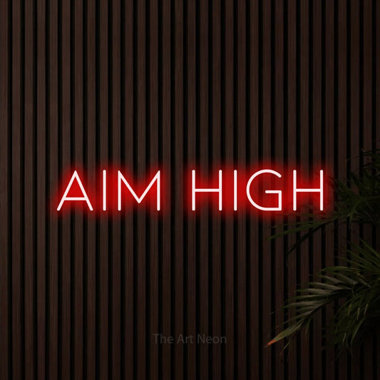 Red LED neon sign reading "Aim High" against dark wooden slats for office décor