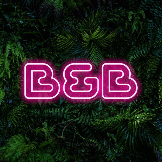 Hot pink outline-style LED neon sign reading "B&B" against a dense tropical foliage wall for hotel décor