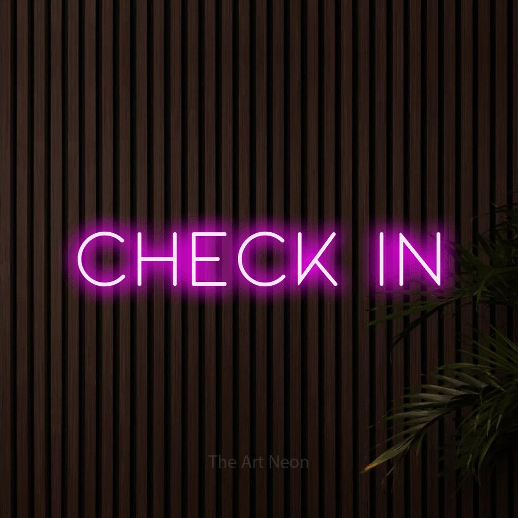 Pink LED neon sign reading "Check In" against dark wooden slats for hotel décor