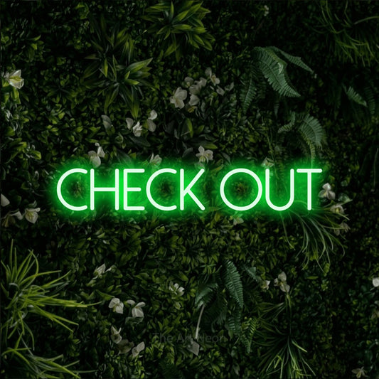 Green LED neon sign reading "Check Out" against a leafy green wall for hotel décor