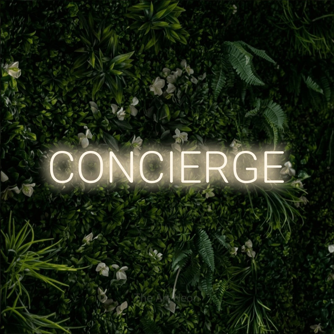 Warm white LED neon sign reading "Concierge" against a leafy green wall for hotel décor