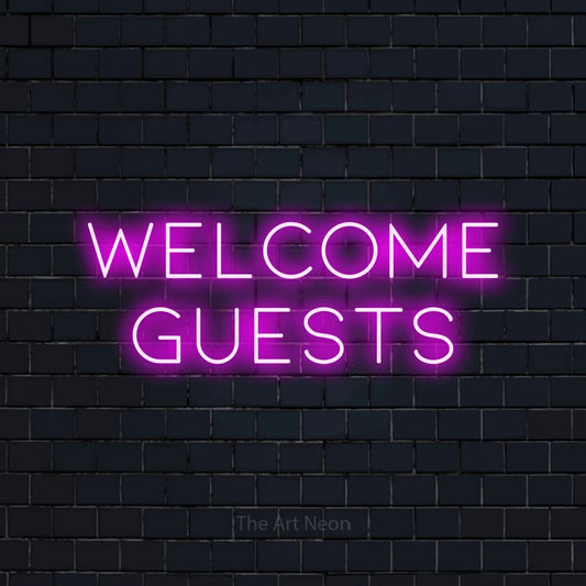 Pink LED neon sign reading "Welcome Guests" against a dark navy brick wall for hotel décor