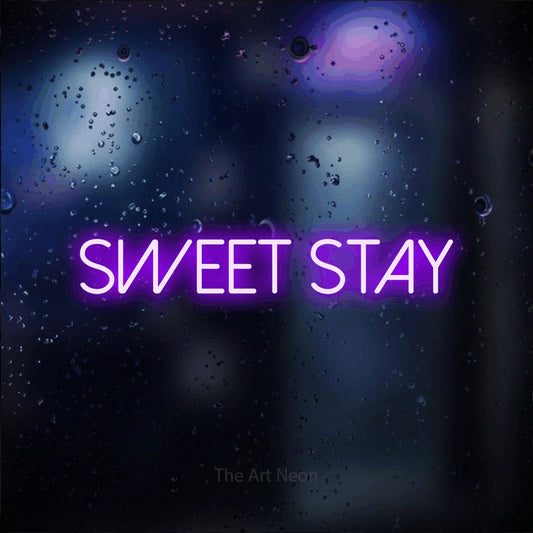 Purple LED neon sign reading "Sweet Stay" against a dark blue bokeh background for hotel décor