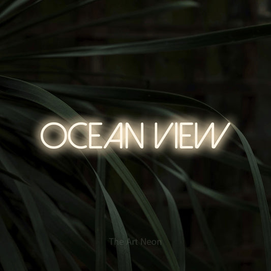 Warm white LED neon sign reading "Ocean View" against dark tropical leaves for hotel décor