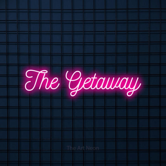 Hot pink script-style LED neon sign reading "The Getaway" against a dark blue tiled wall for hotel décor