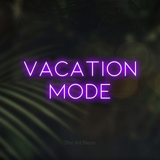Purple LED neon sign reading "Vacation Mode" against dark blurred palm leaves for hotel décor