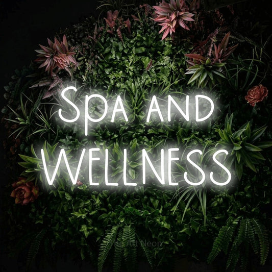 Cool white LED neon sign reading "Spa and Wellness" against a flowering garden wall for hotel décor