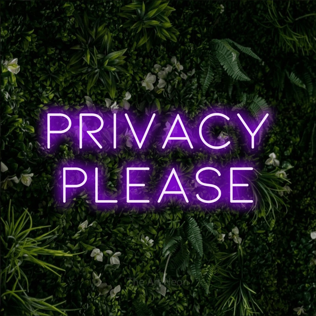 Purple LED neon sign reading "Privacy Please" against a leafy green wall for hotel décor