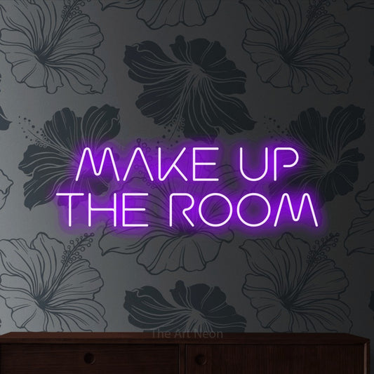 Purple LED neon sign reading "Make Up the Room" against grey floral wallpaper for hotel décor