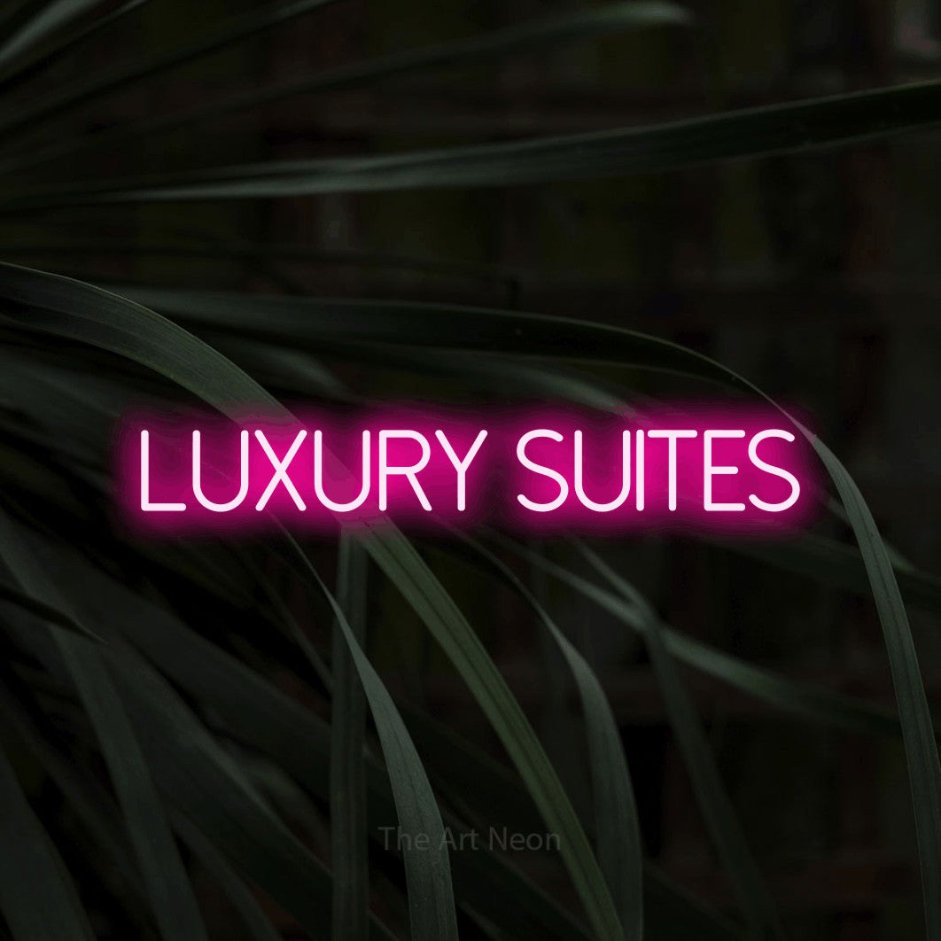 Enseigne néon à DEL à lumière rose vif, affichant « Luxury Suites » sur des feuilles tropicales foncées, pour décorer un hôtel