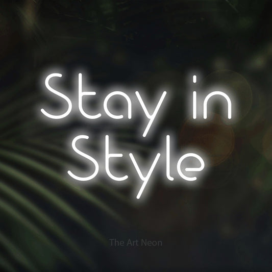 Cool white LED neon sign reading "Stay in Style" against dark blurred palm leaves for hotel décor