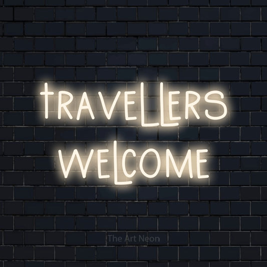 Warm white LED neon sign reading "Travellers Welcome" against a dark navy brick wall for hotel décor