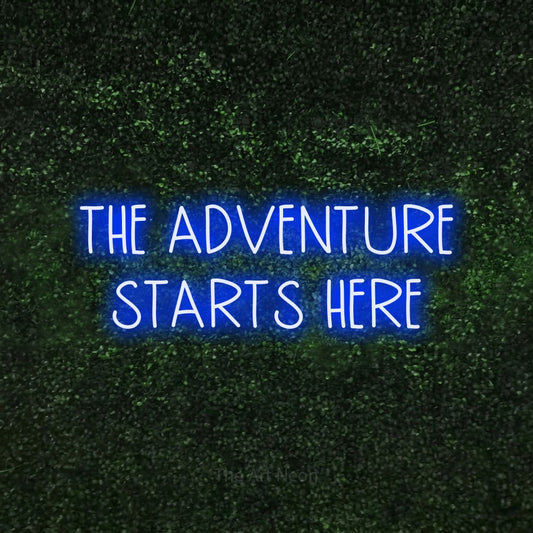 Blue LED neon sign reading "The Adventure Starts Here" against a textured green moss wall for hotel décor