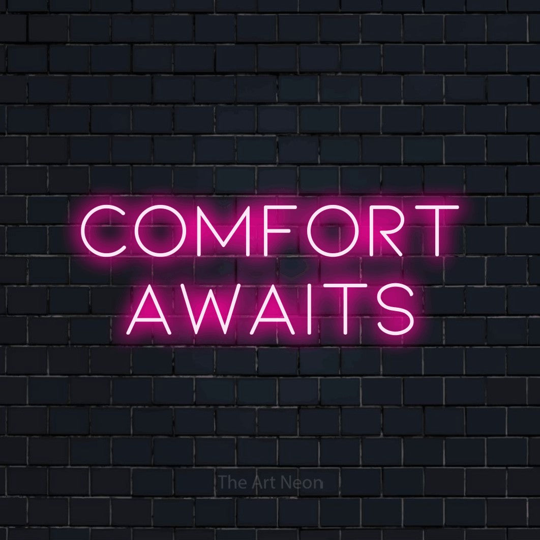 Enseigne néon à DEL à lumière rose vif, affichant « Comfort Awaits » sur un mur de briques bleu marine foncé, pour décorer un hôtel