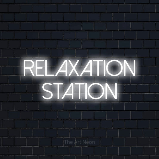 Cool white LED neon sign reading "Relaxation Station" against a dark navy brick wall for hotel décor