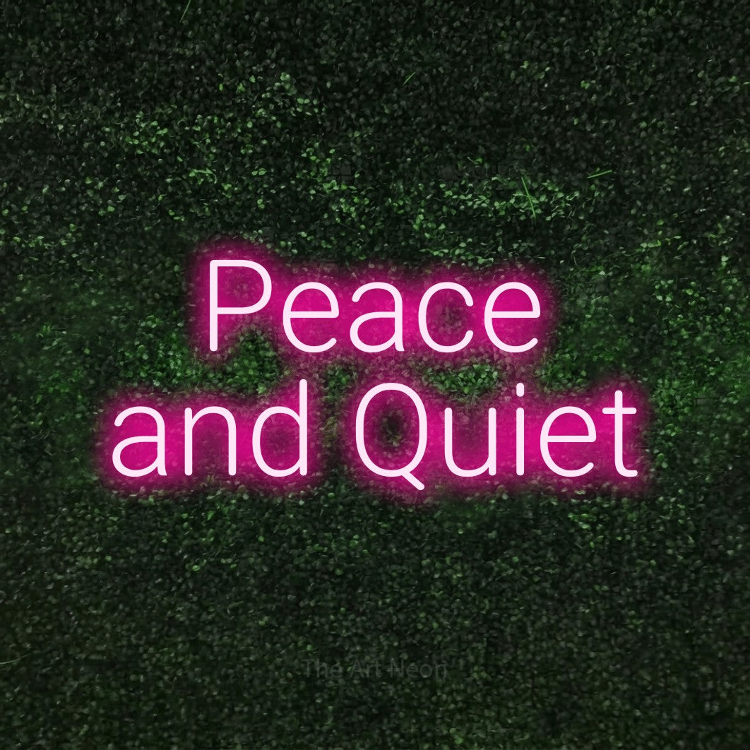 Hot pink LED neon sign reading "Peace and Quiet" against a textured green moss wall for hotel décor