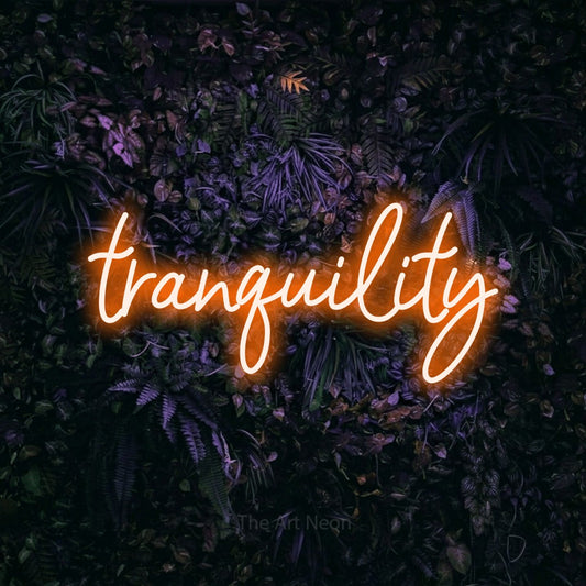 Orange script-style LED neon sign reading "Tranquility" against a purple floral wall for hotel décor