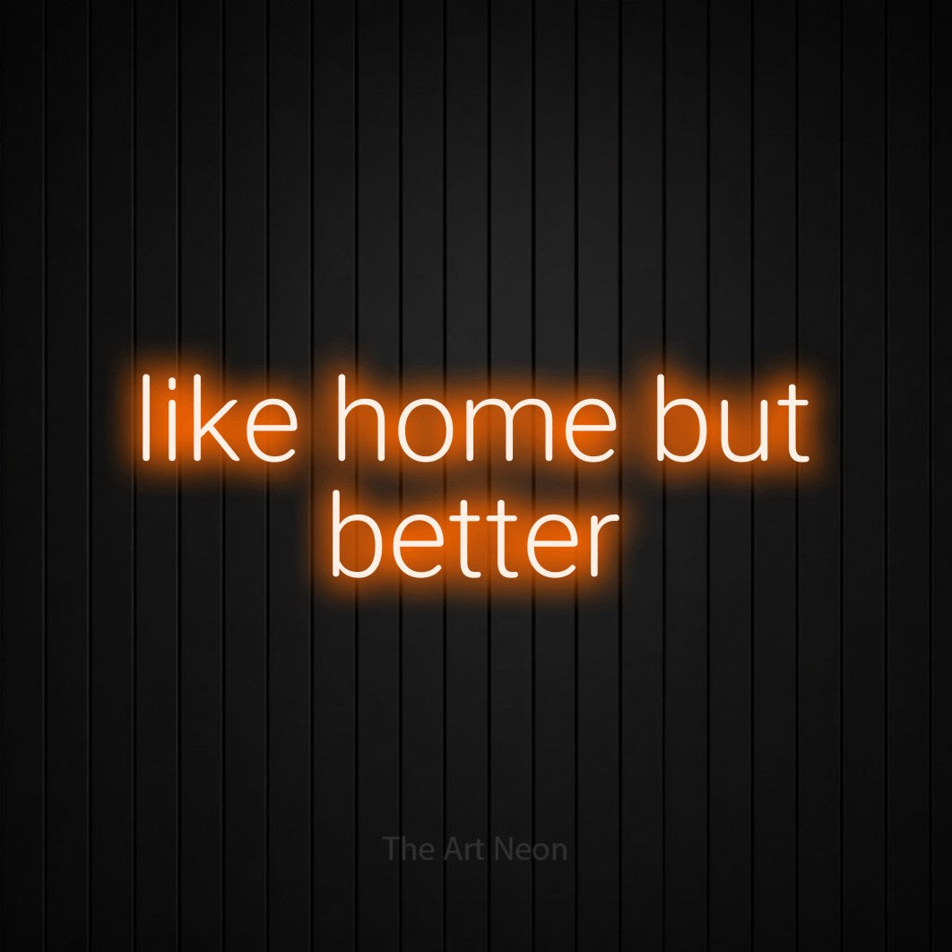 Orange LED neon sign reading "Like Home but Better" against a black vertical slat wall for hotel décor