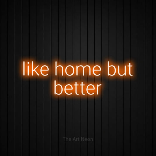 Orange LED neon sign reading "Like Home but Better" against a black vertical slat wall for hotel décor