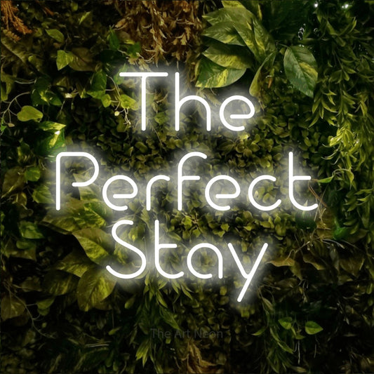 Cool white LED neon sign reading "The Perfect Stay" against a textured moss and foliage wall for hotel décor
