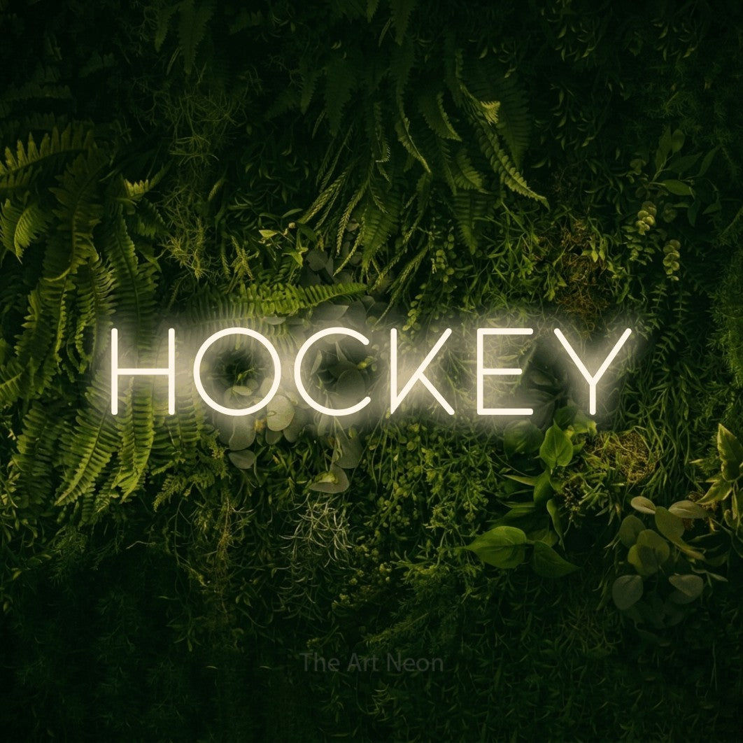 Warm white LED neon sign reading "Hockey" against a moss-covered green wall