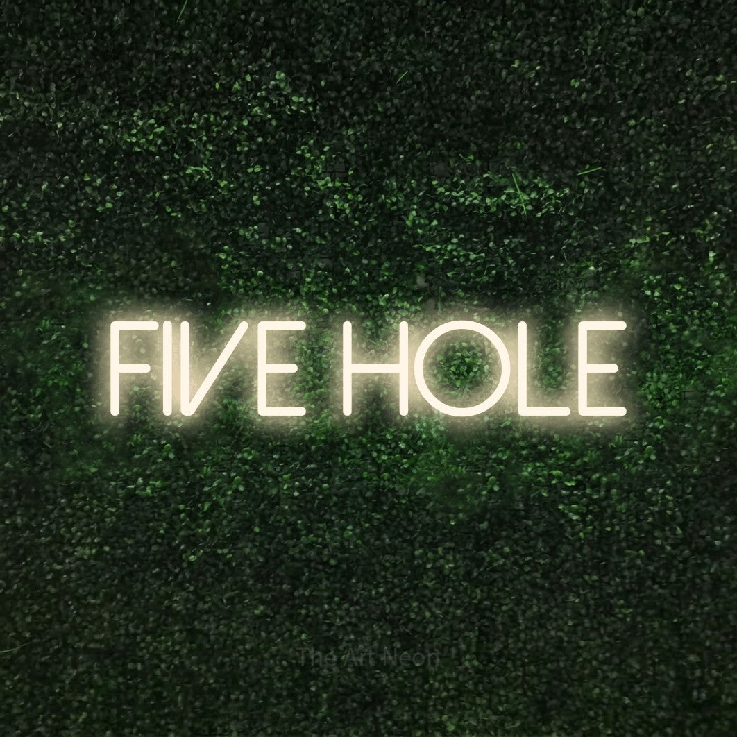 Warm white LED neon sign reading "Five Hole" against a textured green moss wall