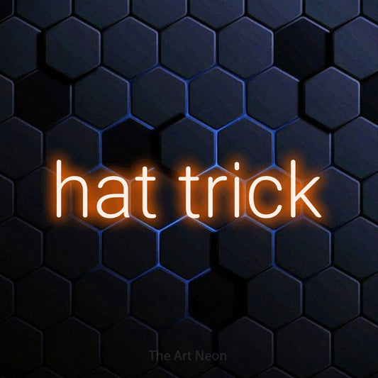 Orange LED neon sign reading "Hat Trick" against a blue hexagonal wall