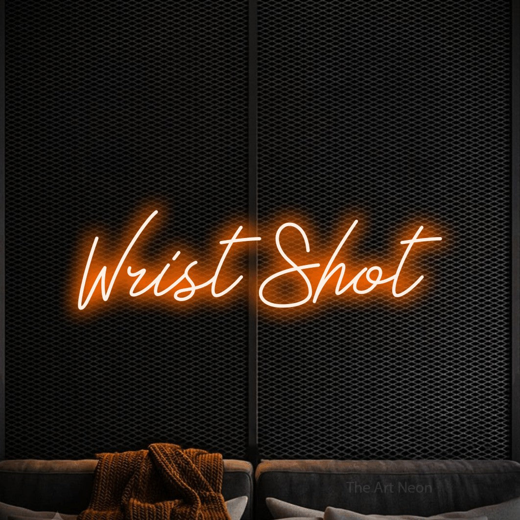 Orange script-style LED neon sign reading "Wrist Shot" against a black textured wall