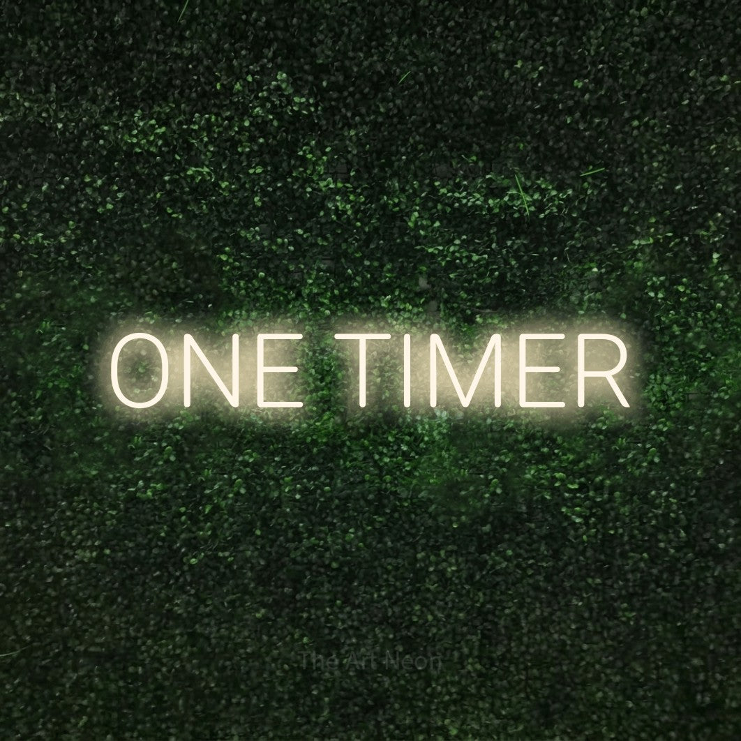 Warm white LED neon sign reading "One Timer" against a textured green moss wall
