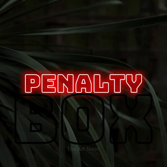 Red outline-style LED neon sign reading "Penalty Box" against dark tropical leaves