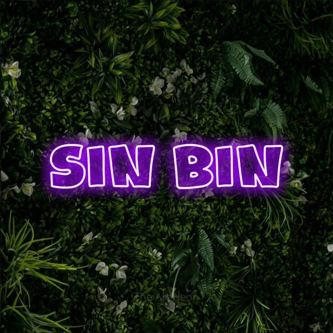 Purple outline-style LED neon sign reading "Sin Bin" against a leafy green wall