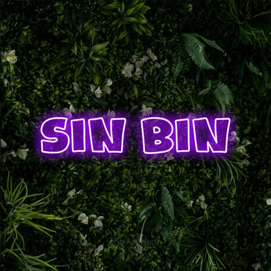 Purple outline-style LED neon sign reading "Sin Bin" against a leafy green wall