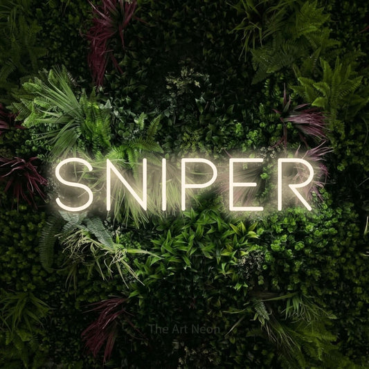Warm white LED neon sign reading "Sniper" against a lush garden wall with pink flowers