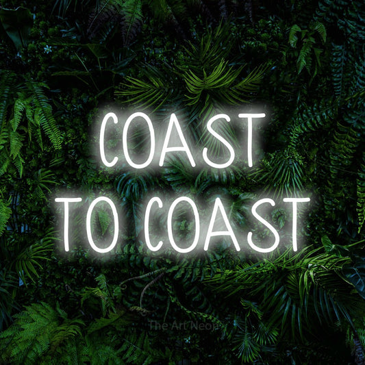 Cool white LED neon sign reading "Coast to Coast" against a dense tropical foliage wall