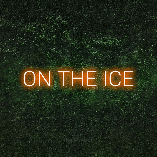 Orange LED neon sign reading "On the Ice" against a textured green moss wall