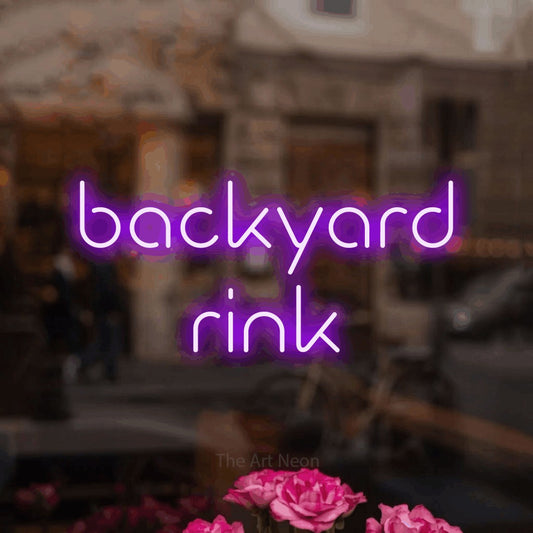 Purple LED neon sign reading "Backyard Rink" in a softly blurred café interior