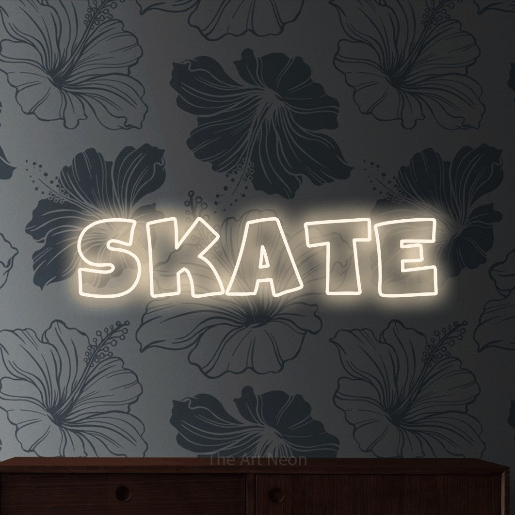 Warm white outline-style LED neon sign reading "Skate" against grey floral wallpaper