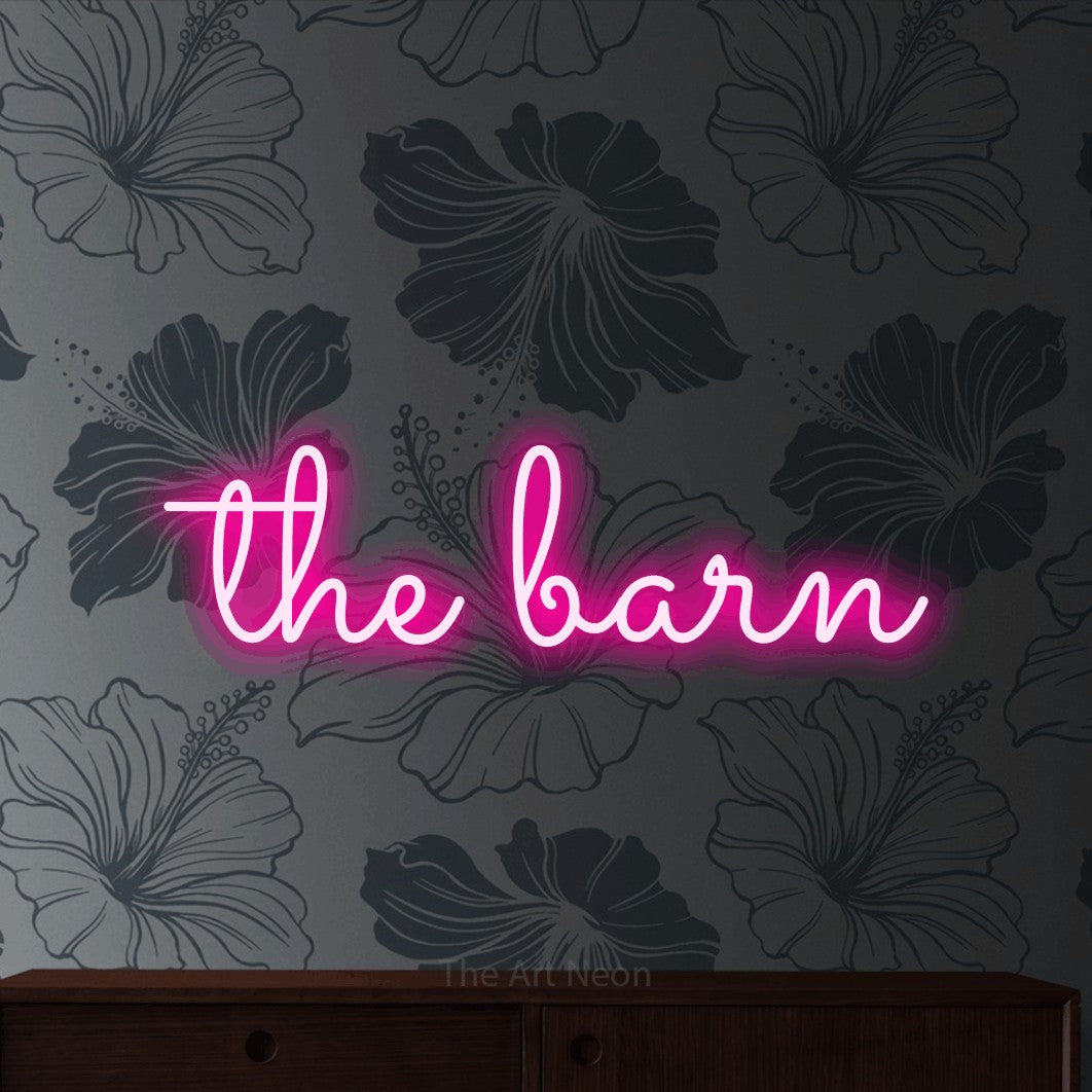Hot pink LED neon sign reading "The Barn" against grey floral wallpaper