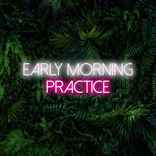 Hot pink and cool white LED neon sign reading "Early Morning Practice" against a dense tropical foliage wall