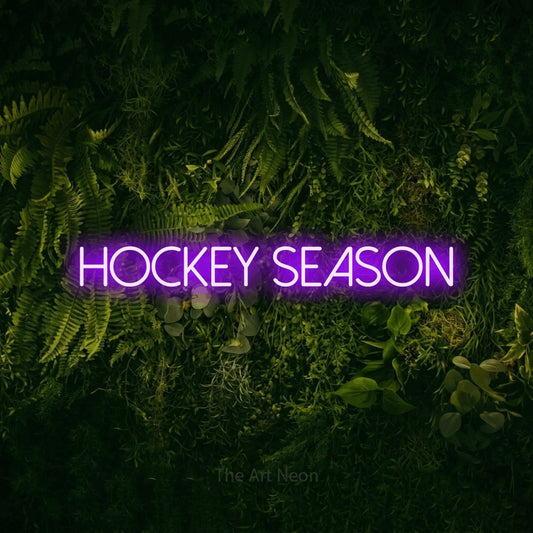 Purple LED neon sign reading "Hockey Season" against a moss-covered green wall