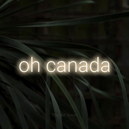 Warm white LED neon sign reading "Oh Canada" against dark tropical leaves