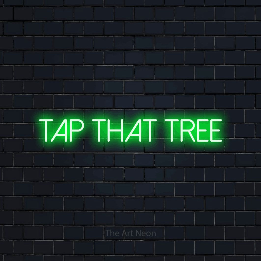 Green LED neon sign reading "Tap That Tree" against a dark navy brick wall